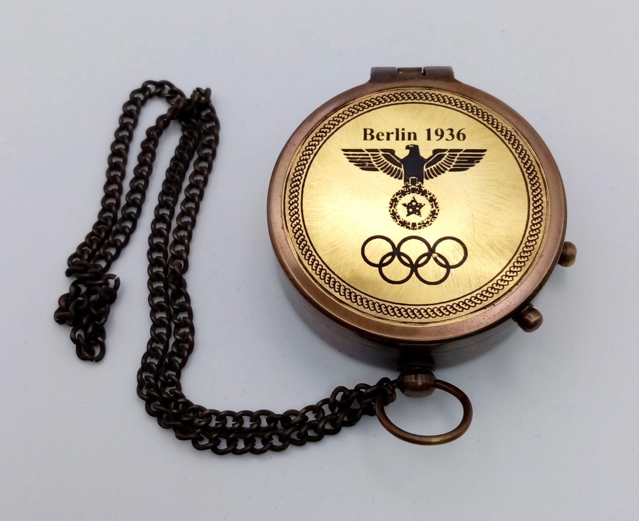 A brass compass with immobiliser, brass chain and inscription BERLIN 1936 in a wooden box with - Image 2 of 6