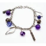 A sterling silver bracelet with amethysts and charms. Weight: 19.8 g.