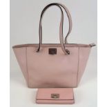 A Michael Kors Pink Shoulder Bag and Matching Purse. Silver toned hardware. Monogrammed interior
