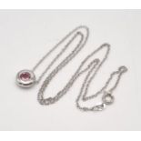 A Floating Pink Tourmaline 18K White Gold Pendant on an 18K white gold chain. 0.55ct tourmaline.