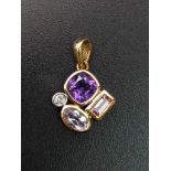 A 9 K yellow gold pendant with diamond and amethysts. weight: 1.3 g.