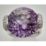 An impressive 18 K white gold cocktail ring with large central amethyst and diamonds on the