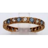 AN 18K GOLD FULL ETERNITY RING WITH ATTRACTIVE BLUE AND WHITE STONES. 2.6gms size Q
