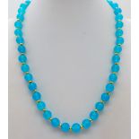 A Blue Topaz Bead Necklace. 8mm beads. Gilded clasp and spacers. 42cm