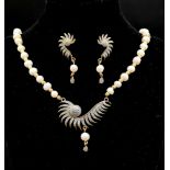 A very elegant, white genuine pearls and cubic zirconia necklace and earrings set. Necklace
