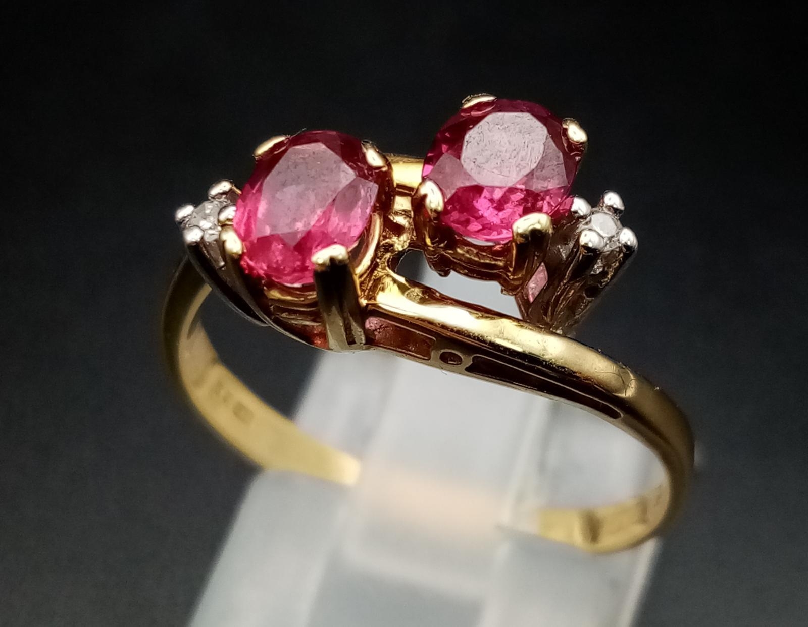 A 9 K yellow gold ring with diamonds and rubies in a twisted design. Ring size: P, weight: 2.6 g.