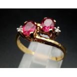 A 9 K yellow gold ring with diamonds and rubies in a twisted design. Ring size: P, weight: 2.6 g.