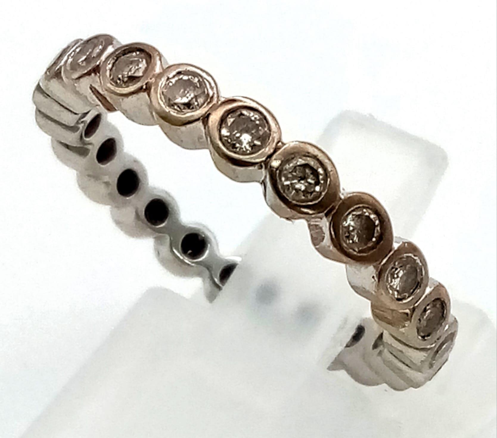 A 950 Platinum Diamond Eternity Ring. Size N. 2.83g total weight.