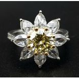 A STUNNING PLATINUM RINGWITH A FANCY YELLOW DIAMOND AT THE CENTRE OF A FLORAL DESIGN SURROUNDED BY