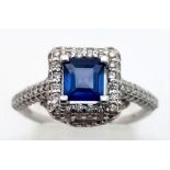 AN 18K WHITE GOLD SAPPHIRE AND ENCRUSTED DIAMOND RING. 4.3gms size M