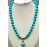 A Turquoise Bead and Pendant Necklace. Gilded decoration. 42 and 3cm. Largest bead 14mm