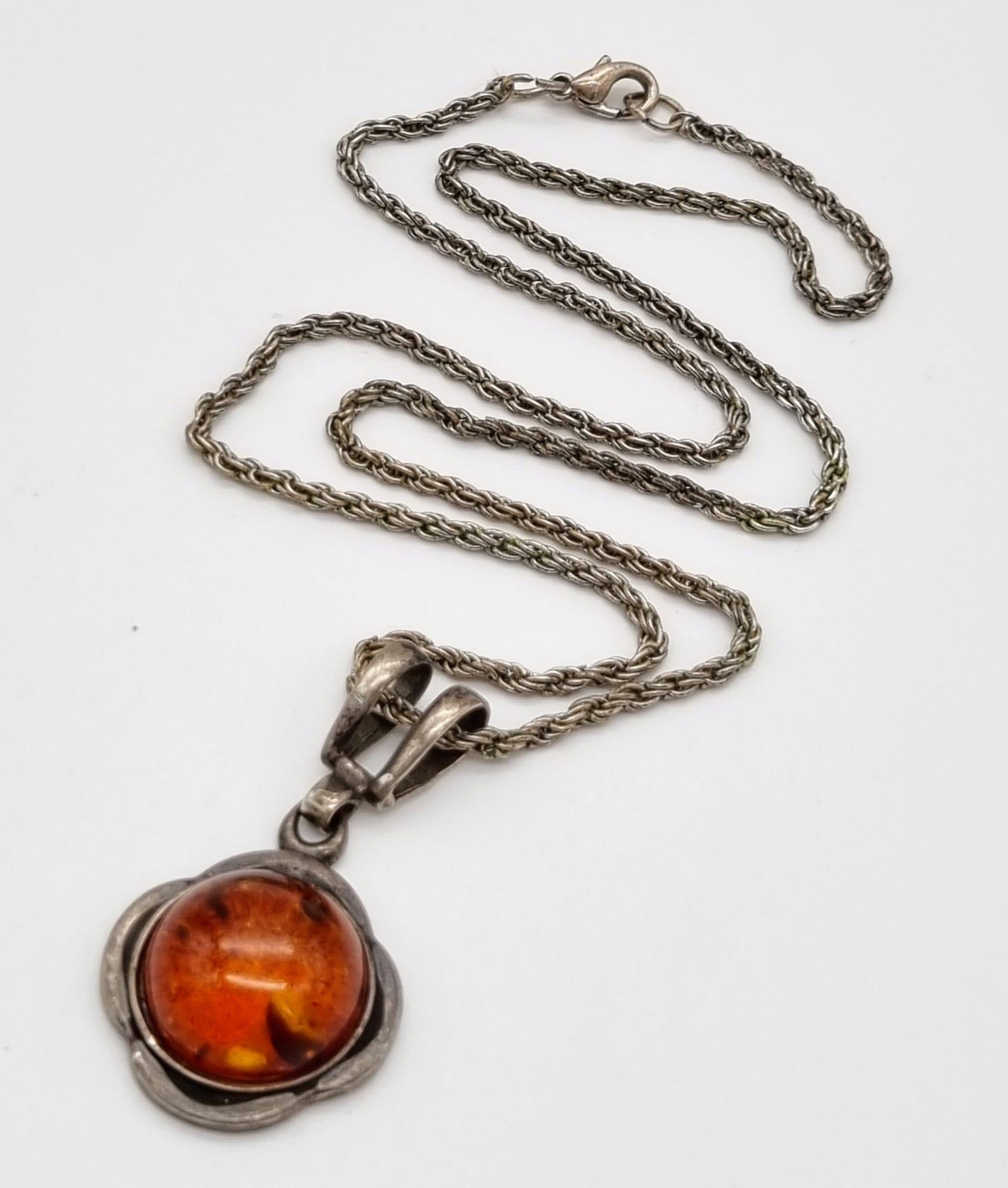 A Vintage Amber Cabochon set in a 925 Silver Pendant -on a vintage necklace. 2 and 46cm.