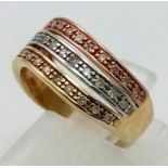 A 9 K three colour gold ring with diamond bands. Diamonds 0.35 carats. Ring size: L, weight: 2.7 g.