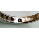 An 18K White Gold Channel-Set Half Eternity Ring. Fifteen diamonds - approx 1ct. Size M. 4.05g. Ref: