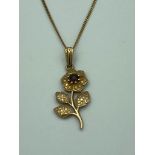 9 carat GOLD FLOWER PENDANT and CHAIN ,having Garnet detail with intricate GOLD work to leaves and