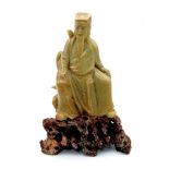 An Antique Chinese Green Soapstone Elder Figure. He sits atop a bed of brown agate. 20 x 13cm. 1238g