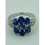 SILVER RING having BLUE and WHITE TOPAZ gemstones set and mounted to top and shoulders with clear m