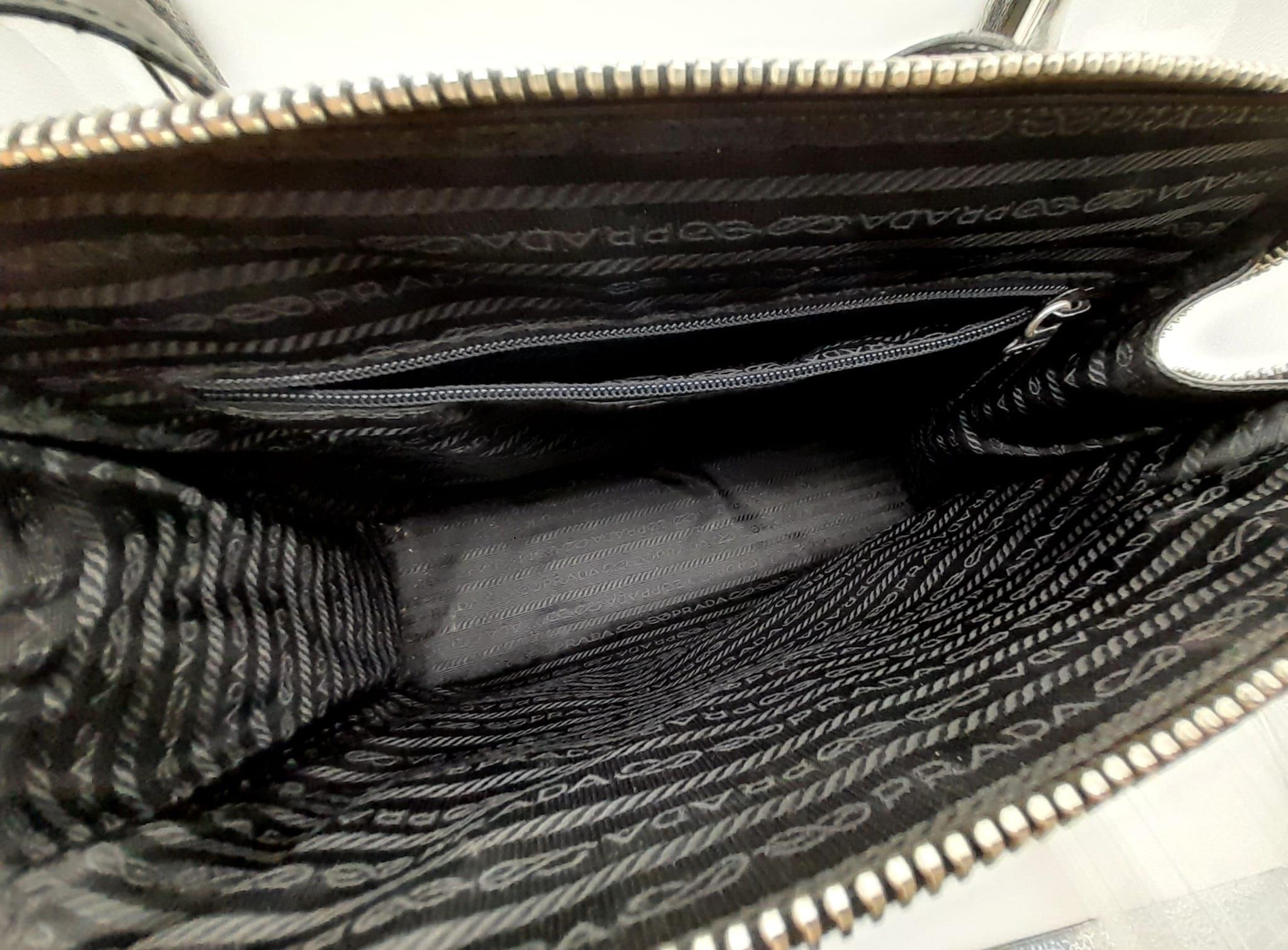 A Prada Patent Black Leather Shoulder Bag. Prada branding on exterior. Cloth monogram interior with - Image 3 of 5