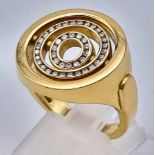An 18K Yellow Gold Garrad Double-Halo Spinning Diamond Ring. 45 brilliant round cut diamonds. Size Q