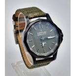 A Corum Admiral's Cup Gents Watch. Green fabric strap. Black steel case - 42mm. Green dial with sub