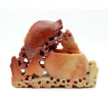 An Antique Chinese Red and Cream Soapstone Leaping Fish Figure. 19 x 16cm. Markings on pot.