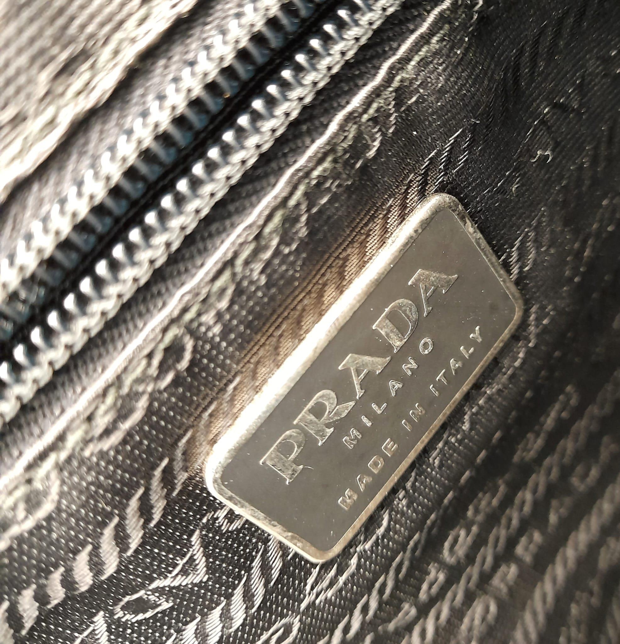 A Prada Patent Black Leather Shoulder Bag. Prada branding on exterior. Cloth monogram interior with - Image 4 of 5