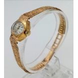 A 9k Gold Vintage Rotary Ladies Watch. 9k Gold strap and case - 15mm. Tree-Bark effect on strap. Mec