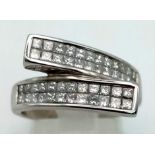 A 9K White Gold Diamond Crossover Cluster Ring. 48 small square cut diamonds over two crossover wing