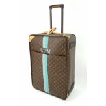A Louis Vuitton Monogram Suitcase. Brown canvas with leather handle and gilded hardware. On wheels w