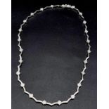 An 18K White Gold and Diamond Set Collar Necklace. 0.60ct. 20.3g total weight. 42cm