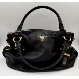 A Prada Soft Black Leather Small Tote/hand Bag. Gilded hardware and Prada logo. Prada monogram inter