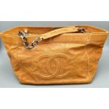 A Chanel Brown Leather Tote Bag. Chanel monogram on outer. Silver tone chain hardware. Soft diamond