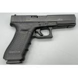 A Deactivated 9mm Glock Model 17 Generation 4 Semi-Automatic Pistol. Comes with extra grip sets and