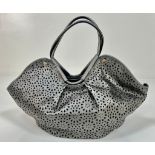 A Jimmy Choo Star Perforated Leather Tote Bag. Silver and black exterior. One interior open and one