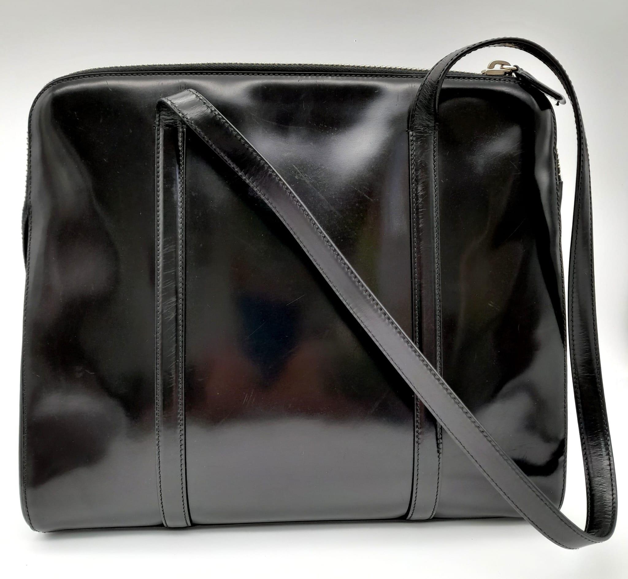 A Prada Patent Black Leather Shoulder Bag. Prada branding on exterior. Cloth monogram interior with - Image 2 of 5