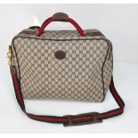 A Gucci Ophidia Small Suitcase/Carry On. Gucci monogram canvas exterior. Red and green handles