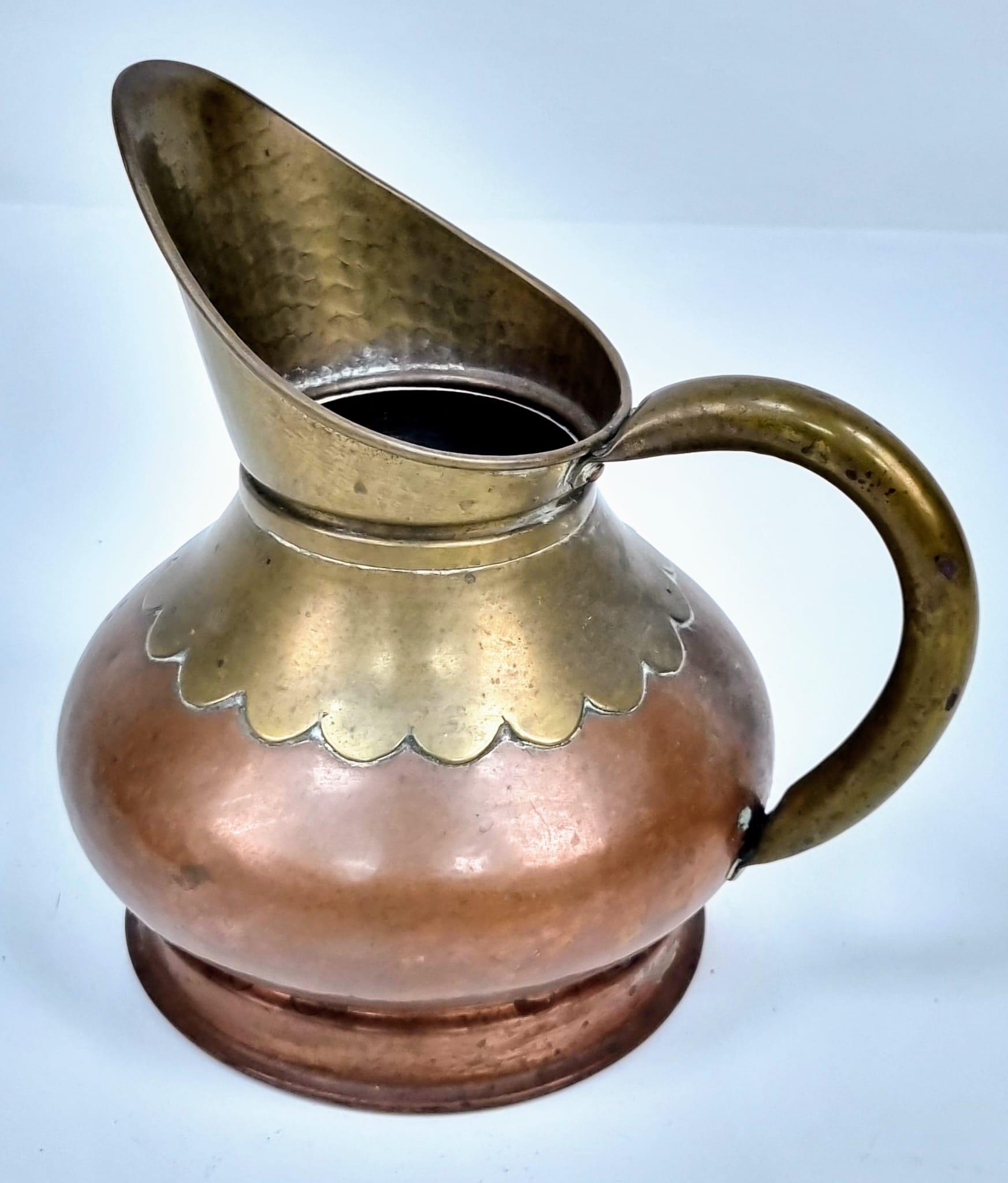 A pair of Copper and Brass jugs. One large and one small. Measurements: Large one, 315×250mm. - Image 8 of 9