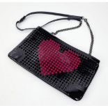 A Christian Louboutin Patent Leather Valentine Clutch Bag. Black and red exterior studs. Red cloth