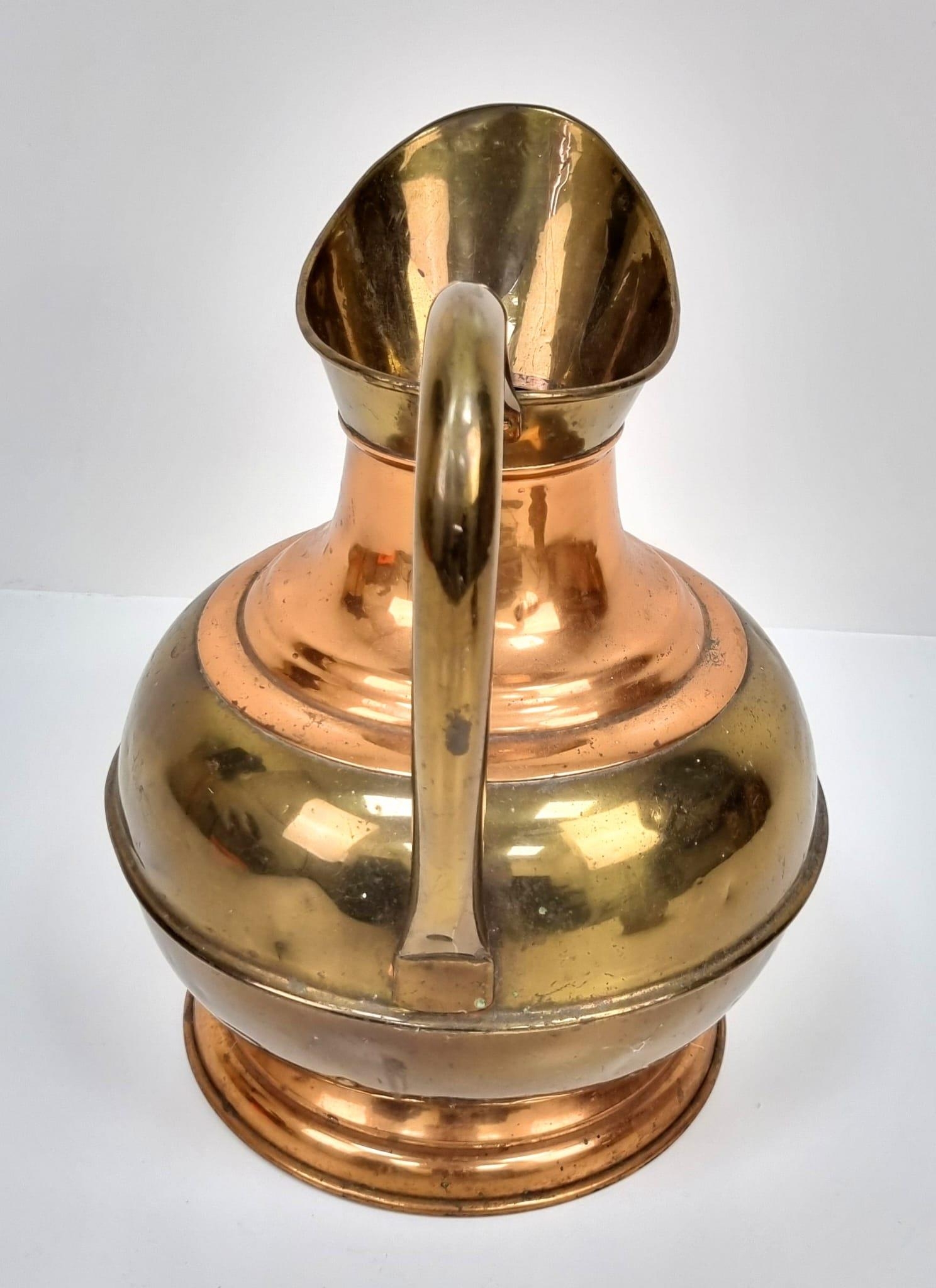 A pair of Copper and Brass jugs. One large and one small. Measurements: Large one, 315×250mm. - Image 3 of 9