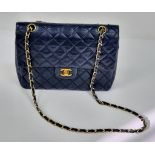 A Classic Chanel Navy Blue Calfskin Flap Bag. Gilded hardware with the iconic Chanel clasp.
