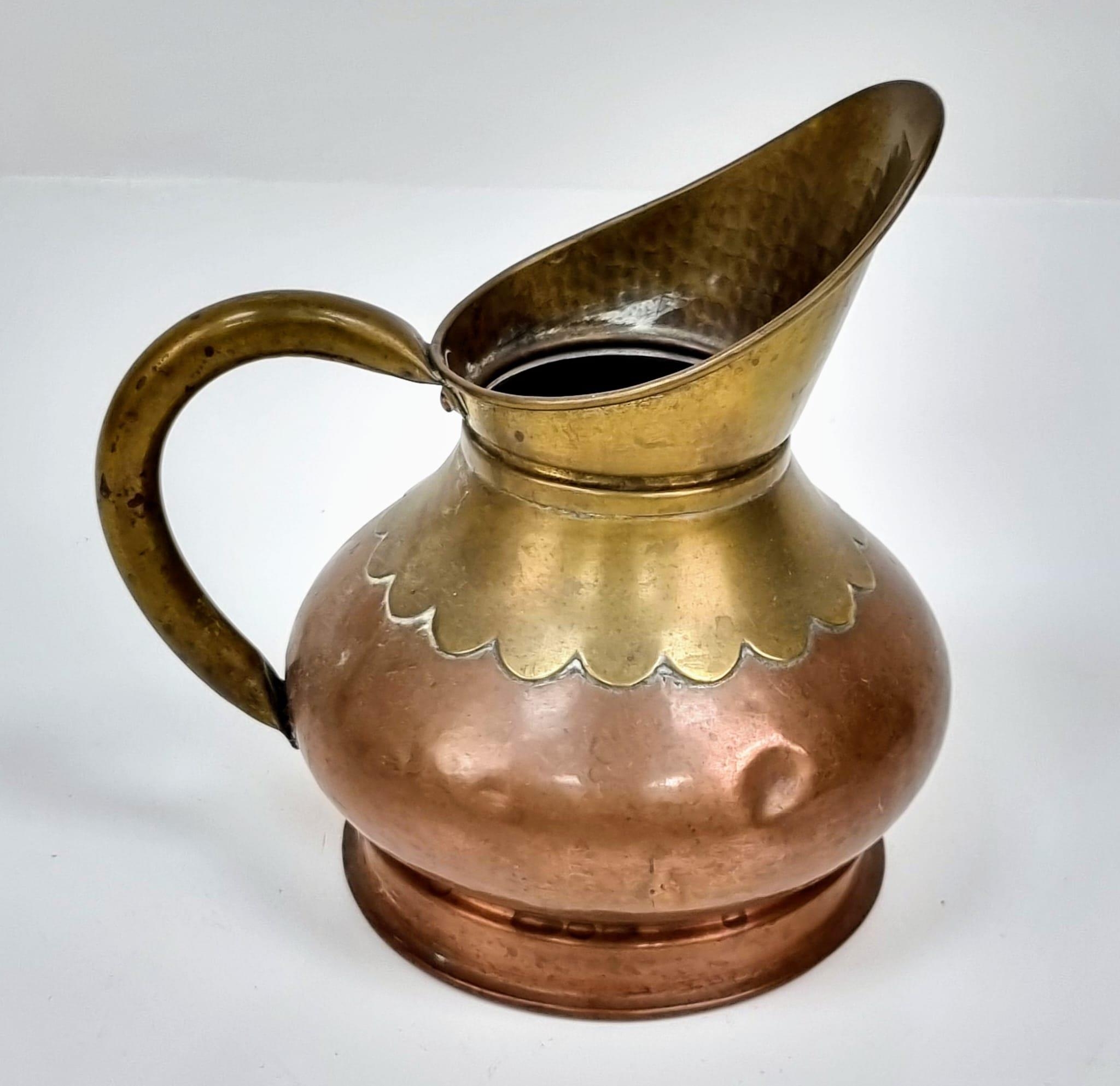 A pair of Copper and Brass jugs. One large and one small. Measurements: Large one, 315×250mm. - Image 7 of 9