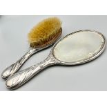 An Antique Sterling Silver Hairbrush and Hand-Mirror. Repoussé floral decoration. Hallmarks for