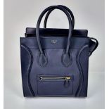 A Celine of Paris Black Leather Small Tote Bag. Exterior pocket for convenience. Interior zipped and