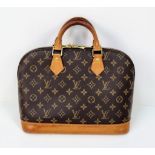 A Louis Vuitton Monogram Canvas Hand Bag. Brown leather and gilded hardware. Cloth interior with