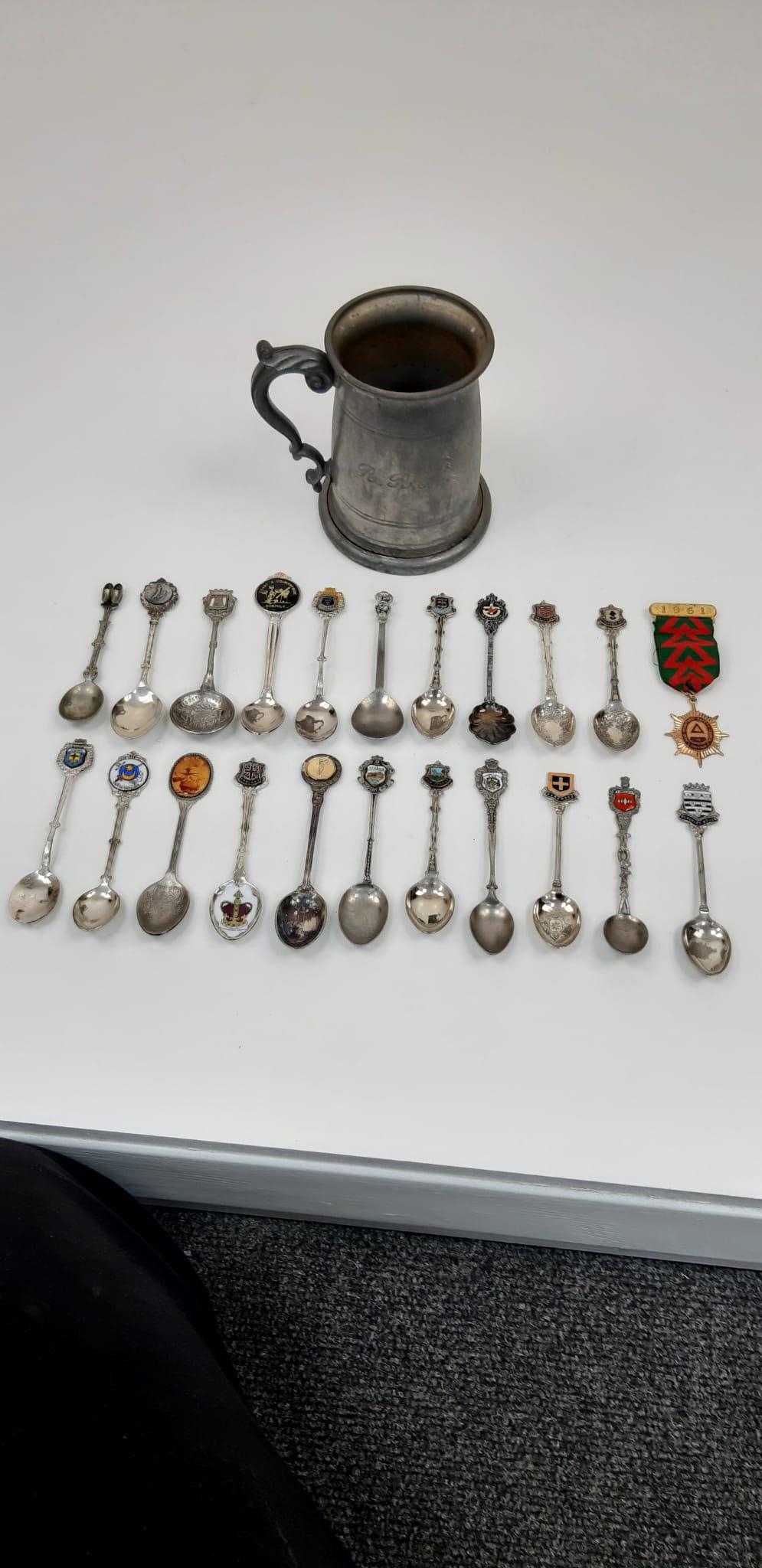 An interesting lot of over 20 collectable silver plated spoons AND an English pewter jug with a