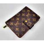 A Louis Vuitton Monogram Canvas Purse/Wallet. Zipped interior compartment. Wallet pocket section. In