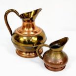 A pair of Copper and Brass jugs. One large and one small. Measurements: Large one, 315×250mm.