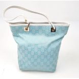 A Baby-Blue Coloured Monogrammed Gucci Canvas Bag. White leather and silver-grey cloth interior with