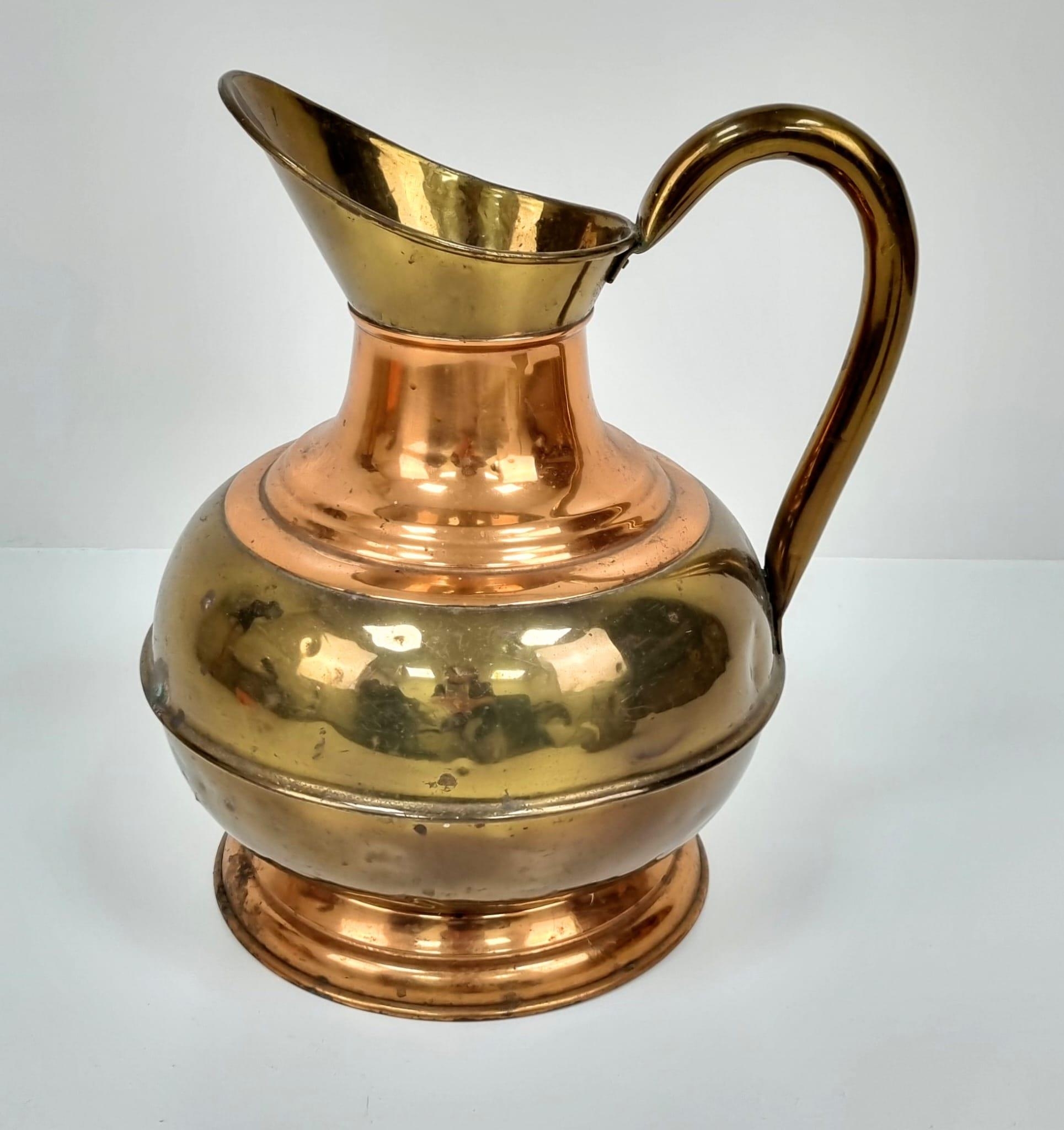 A pair of Copper and Brass jugs. One large and one small. Measurements: Large one, 315×250mm. - Image 4 of 9