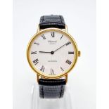 A Chopard 18k Gold Cased Automatic Gents Watch. Black leather strap. Gold case - 33mm. White dial.
